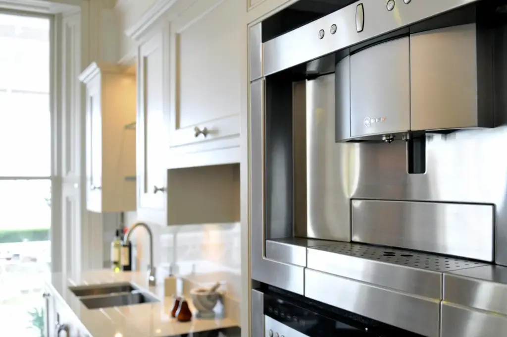 Handmade kitchen in Worthing with built-in stainless steel coffee machine and bespoke cabinetry by Downland & Scullery