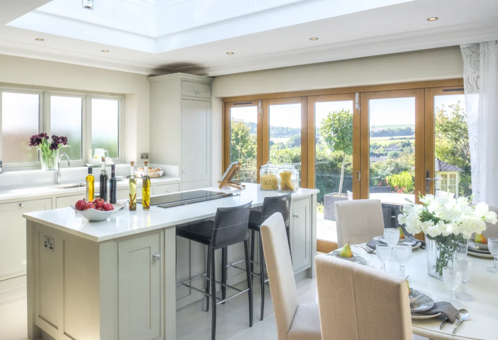 Bright, modern kitchen with island, seating, and stunning garden view.