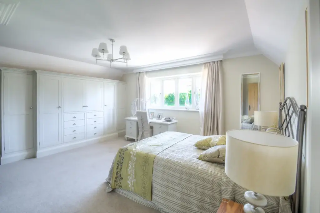 Handmade bedroom wardrobes and dressing table in a light-filled Worthing home, crafted by Downland & Scullery.